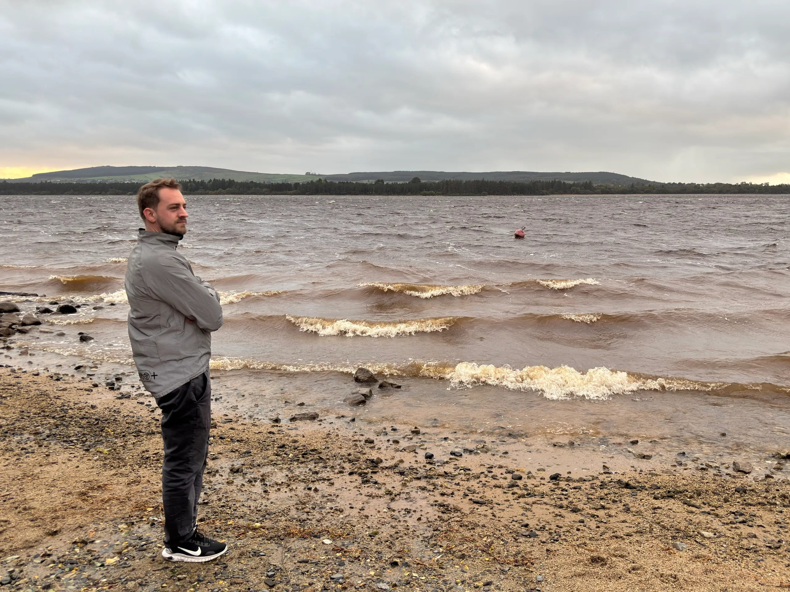 Standing at the edge of a windy lake